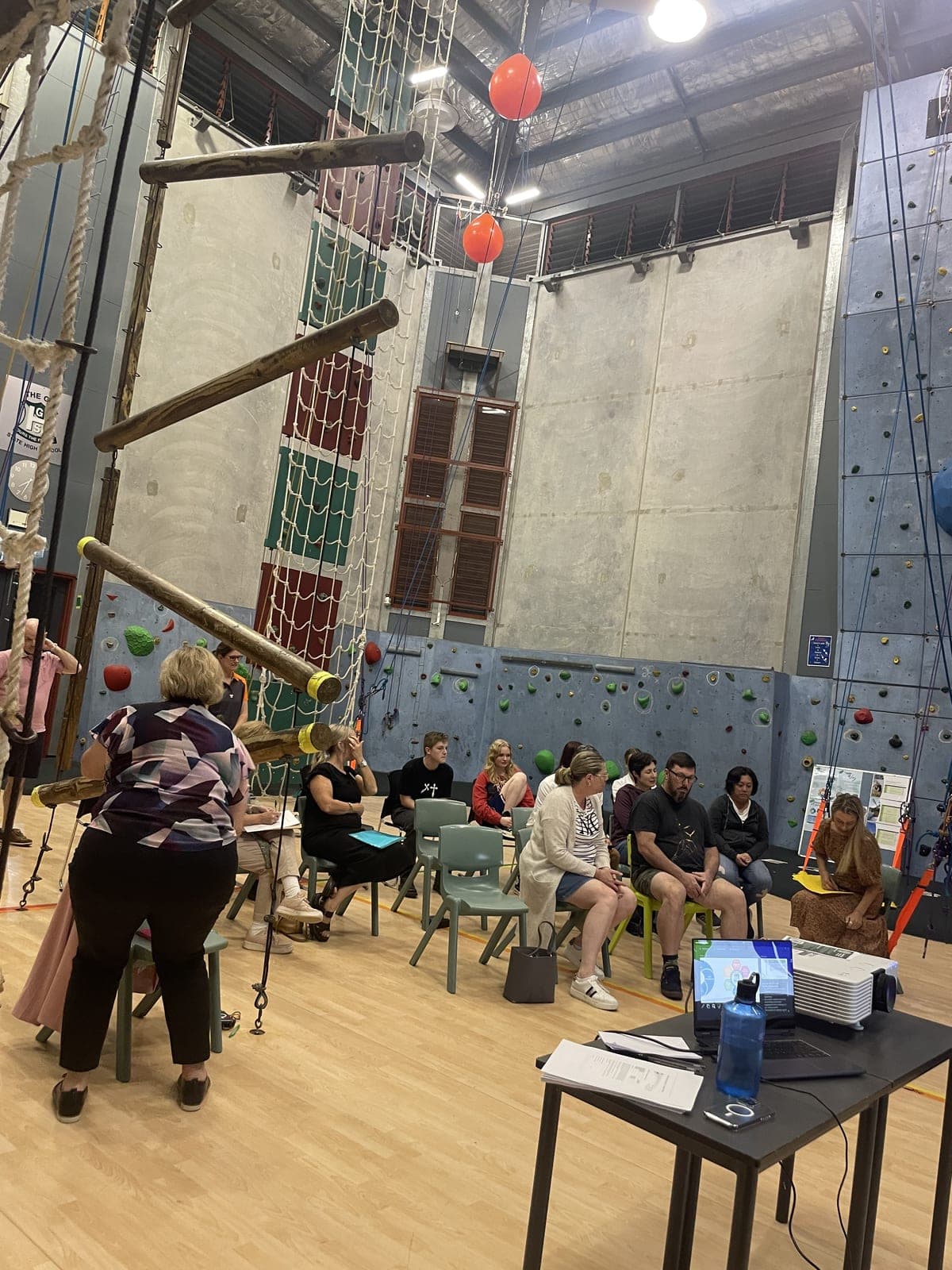 Parents and caregivers seated for a P&C meeting in the school's indoor climbing centre